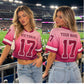 Women's custom crop football jersey worn at football stadium with personalized name and number
