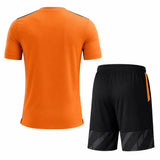 Orange soccer jersey with black football shorts team uniform