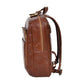 Side view of the structured Peru Tan leather backpack highlighting its slim profile, durable brass zippers, and contoured shoulder strap design