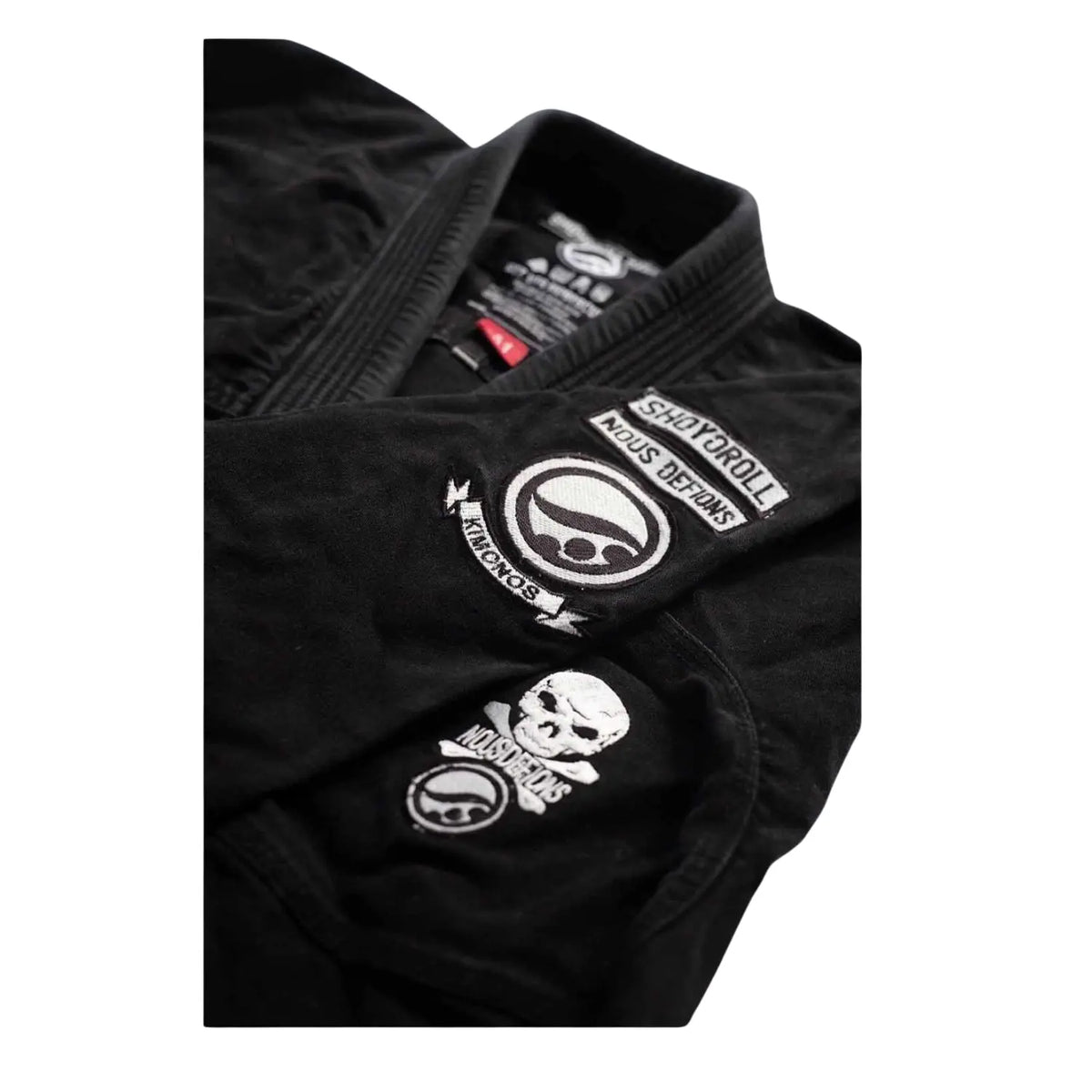 Shoyoroll Batch 66 Mission22 Project BJJ Gi close-up showing embroidered patches and black fabric