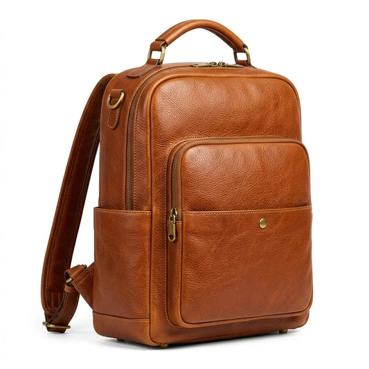 The Pemberton genuine cognac brown cowhide leather backpack front view antique brass hardware laptop sleeve by Trico Gear