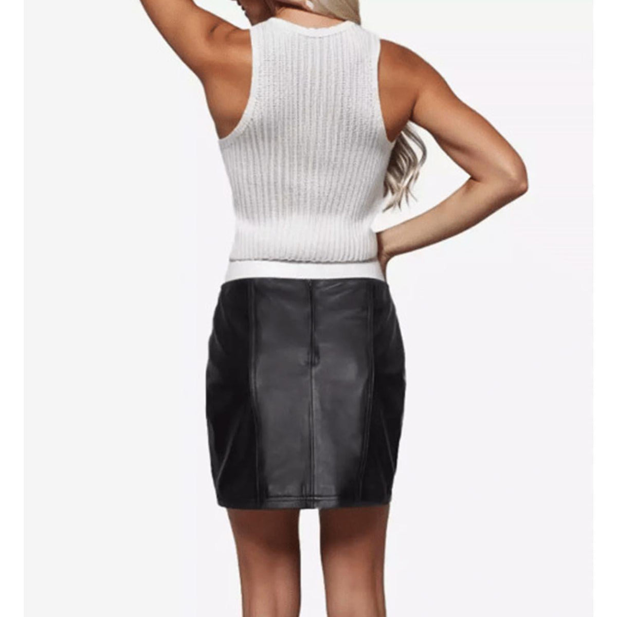 Back view of the tailored women's black leather mini skirt revealing the clean vertical spine stitching, smooth contouring, and hidden rear zip area