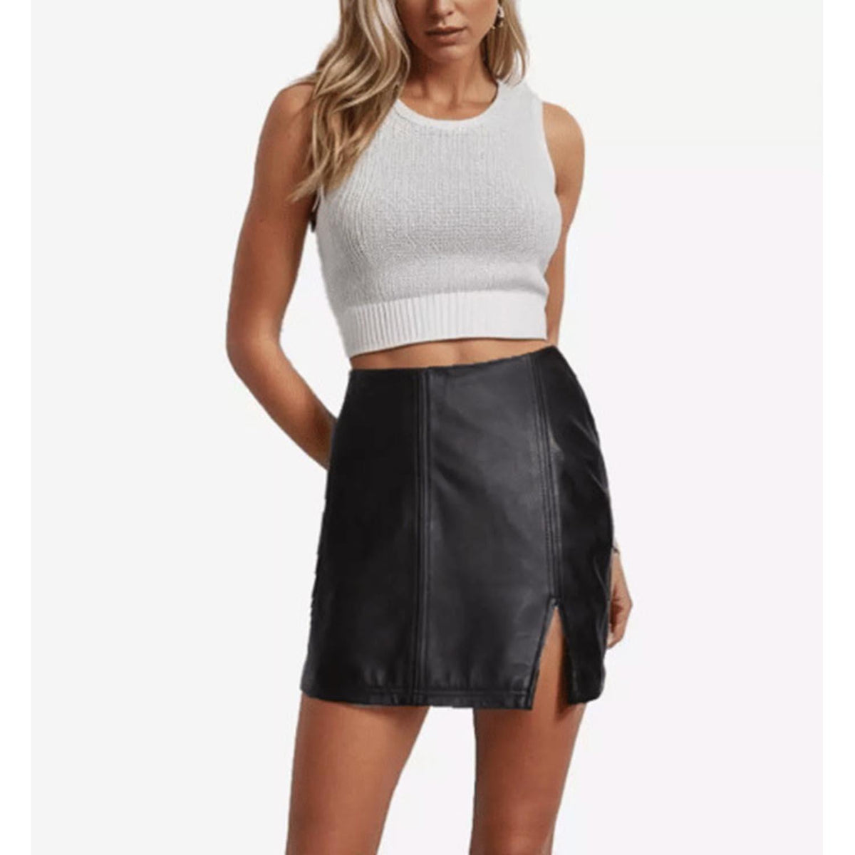 Front view of The Stella women's high-waisted black leather mini skirt highlighting the vertical panel seam design and distinct thigh-high front side slit