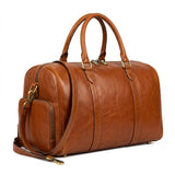 The Stratford genuine cognac brown cowhide leather duffle bag front view antique brass hardware rolled handles by Trico Gear