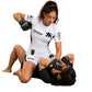 Women's TricoGear Apex white BJJ rash guard and grappling shorts during No-Gi grappling training