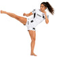 Women's TricoGear Apex white BJJ No-Gi training set shown in martial arts kicking action