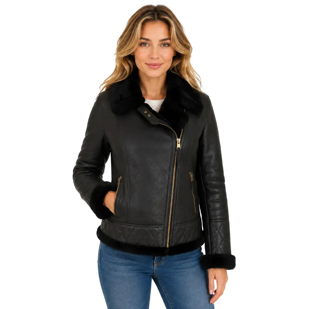 Women's black B3 sheepskin leather jacket with detachable hood worn with the collar open, featuring asymmetrical gold zipper and soft black shearling lining.