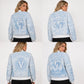 Women’s Unchained embroidered leather bomber jacket modeled from the back